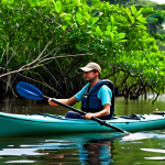 A solo adventurer, fully clothed in modest, lightweight outdoor attire and a life vest, gently paddling a kayak through a tranquil, lush mangrove forest in Guinea. The water is calm and reflects the vibrant green foliage. Exotic birds are visible in the background, adding to the serene atmosphere. Early morning light filters through the dense canopy. Professional photography, high quality, perfect anatomy, correct proportions, natural pose, well-formed hands, proper finger count, natural body proportions, safe for work, appropriate content, family-friendly.